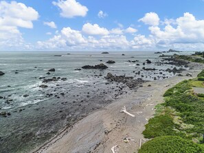 A rocky beach with clear water and scattered rocks.