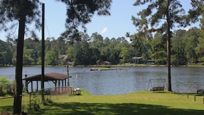 A lakeside park with a gazebo, benches, and a swing set. - !!!Private Lake!!! Fishing, Swimming & MORE!!! Charming Lakeside Bungalow!! (Conroe)
