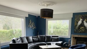 A modern living room with a sectional sofa, a coffee table, and a fireplace.