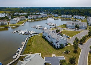 An aerial view of a residential area with a marina, houses, and a road. - Waterfront Marina Home on Private Golf Resort & Pool - 4 miles to OC Boardwalk (Berlin)