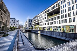 A modern building with a water canal in front. - Comwell Copenhagen Portside Dolce by Wyndham (Copenhagen)