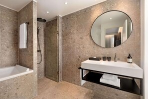 A modern bathroom with a bathtub, shower, and vanity. - Comwell Copenhagen Portside Dolce by Wyndham (Copenhagen)