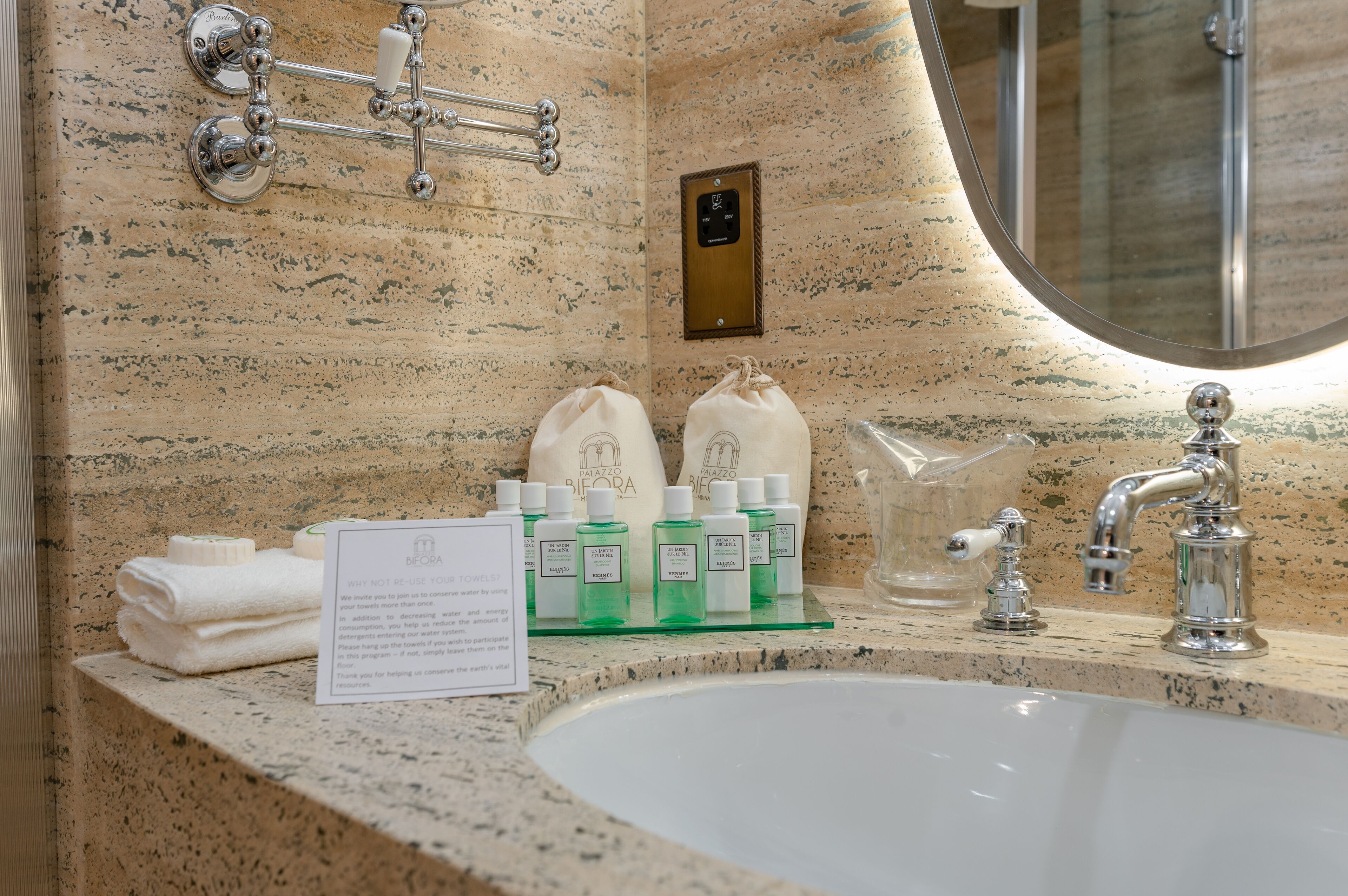 A bathroom with a sink, towel rack, and toiletries.