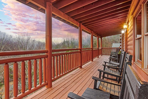 A wooden deck with benches, a railing, and a view of the landscape. - Heated In-Cabin Pool~Theatre~Game Room~Views (Sevierville)