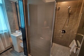 A modern bathroom with a glass shower enclosure, a sink, and a towel rack. - Shangyuan Chain Hotel Guangzhou Railway Station (Guangzhou)