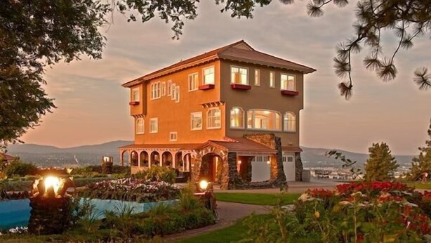 A multi-story building with a garden and pool area.