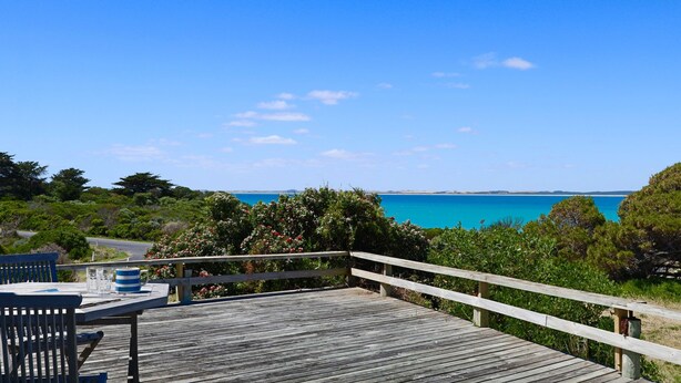 A wooden deck with a railing overlooking a clear blue sea and distant land. - Kalimna - 360 degree ocean and marina views! (Robe)