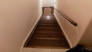 A narrow stairway with a handrail, leading to a door at the top. - Save Time Commuting! North Side Suite 5 Min Walk to Site Bus Studio Basement (Fort McMurray)