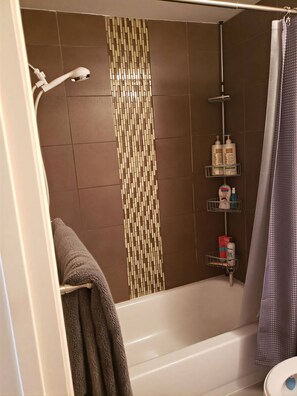 Bathtub, hair dryer, towels, soap