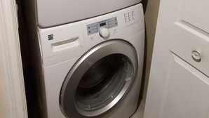 A stacked washer and dryer unit in a laundry room. - Save Time Commuting! North Side Suite 5 Min Walk to Site Bus Studio Basement (Fort McMurray)