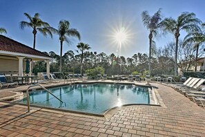 A swimming pool with lounge chairs and palm trees. - Resort Getaway for Families/Groups ~5 Mi to Disney (Kissimmee)