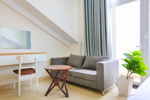 Habitación familiar, varias camas, balcón | Área de sala de estar | Televisión de pantalla plana 