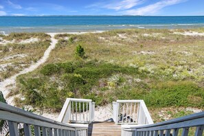 A wooden deck leading to a sandy beach with a view of the ocean. - Beachfront, Quiet shoreline ~ Flamingo Dunes (St. Joe Beach)