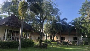 A resort with multiple buildings, each with a tiled roof and surrounded by lush greenery. - Koh Chang Privilege (Ko Chang)