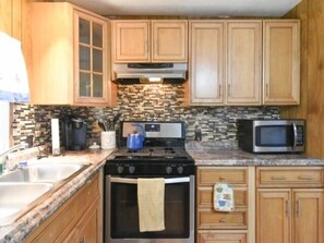Fridge, microwave, stovetop, cookware/dishes/utensils