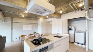A compact kitchen with a central island, built-in oven, and microwave. -  Dai3Himawari 604 (Hiroshima)