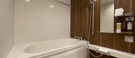 A modern bathroom with a freestanding bathtub, a wooden vanity, and a mirror.