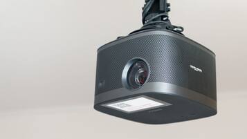 A projector with a QR code and a lens.