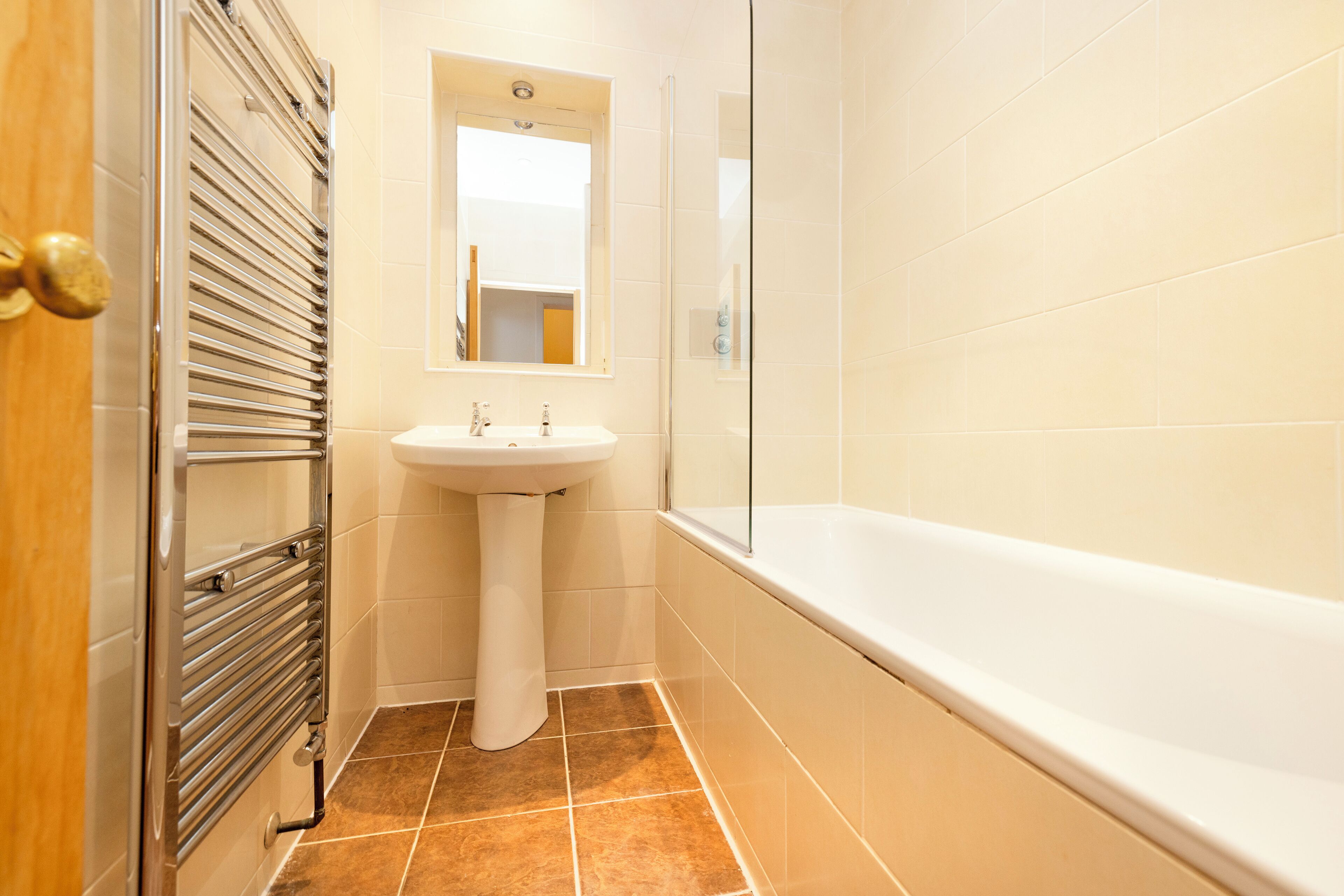 A bathroom with a shower, sink, and bathtub.