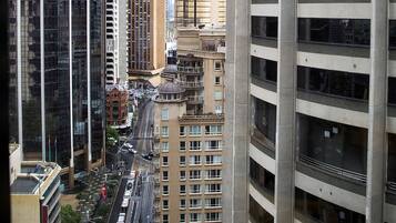 A cityscape with high-rise buildings, including a modern glass skyscraper and a classic building with a dome.