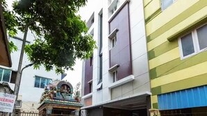 A multi-story building with a gated entrance and a signboard. - Swarnam Residency (Chennai)