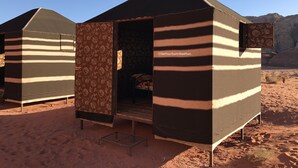A desert tent with a striped pattern and a door open, revealing a bed inside. - Get Your Night in Wadi Rum (Wadi Rum)