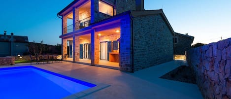 A heated pool, sun loungers