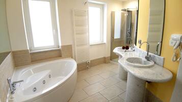 A modern bathroom with a freestanding bathtub, a vanity with a sink, and a large mirror.
