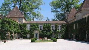 A courtyard with a central garden, surrounded by buildings with a classic architectural style.