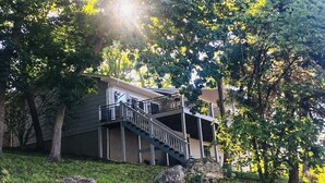 A two-story building with a balcony and a staircase leading to the upper level. - Ozark Outing - a spectacular view of the Lake of the Ozarks (Roach)