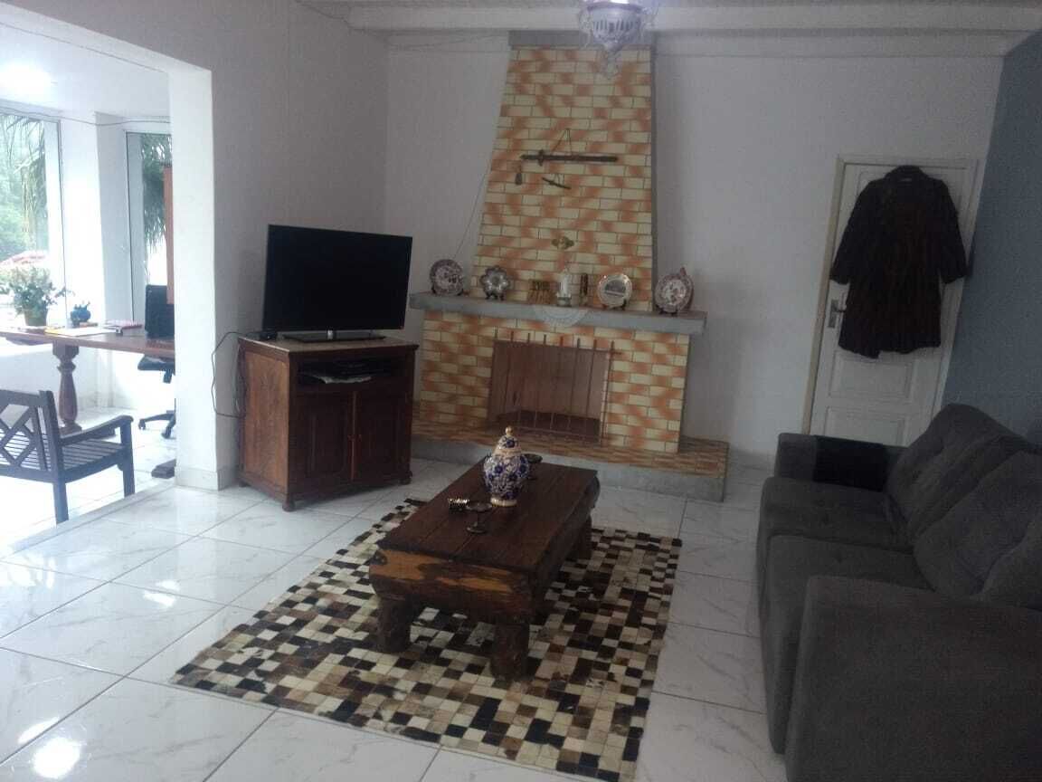 A living room with a fireplace, a television, and a sofa.