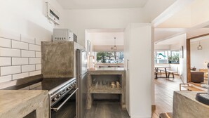 A modern kitchen with a built-in oven, a stainless steel range, and a wine rack. - Modern Space Footsteps from Sea Point Promenade (Cape Town)