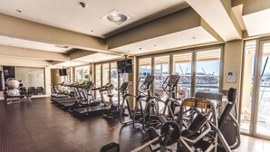 A gym with treadmills, elliptical machines, and weight equipment.