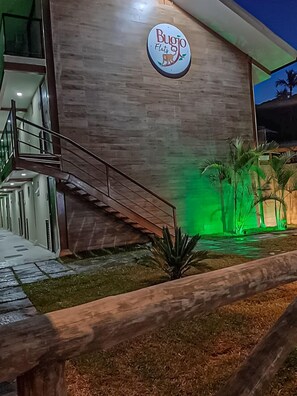 A building with a sign reading "Bugio Flats" and a staircase leading to an entrance. - Bugio Flats (Angra dos Reis)