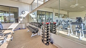 A gym with exercise equipment, mirrors, and a clock on the wall. - Lands End Condo 3Bd/3Bath End Unit with Amazing Main Channel View, Newly Updated (Osage Beach)