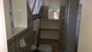 A compact bathroom with a toilet, bidet, and a shower area. - Sea Fano holiday apartment (Fano)