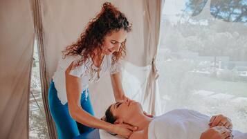 Experience a soothing massage in a peaceful environment, complete with a bathtub and serene views.