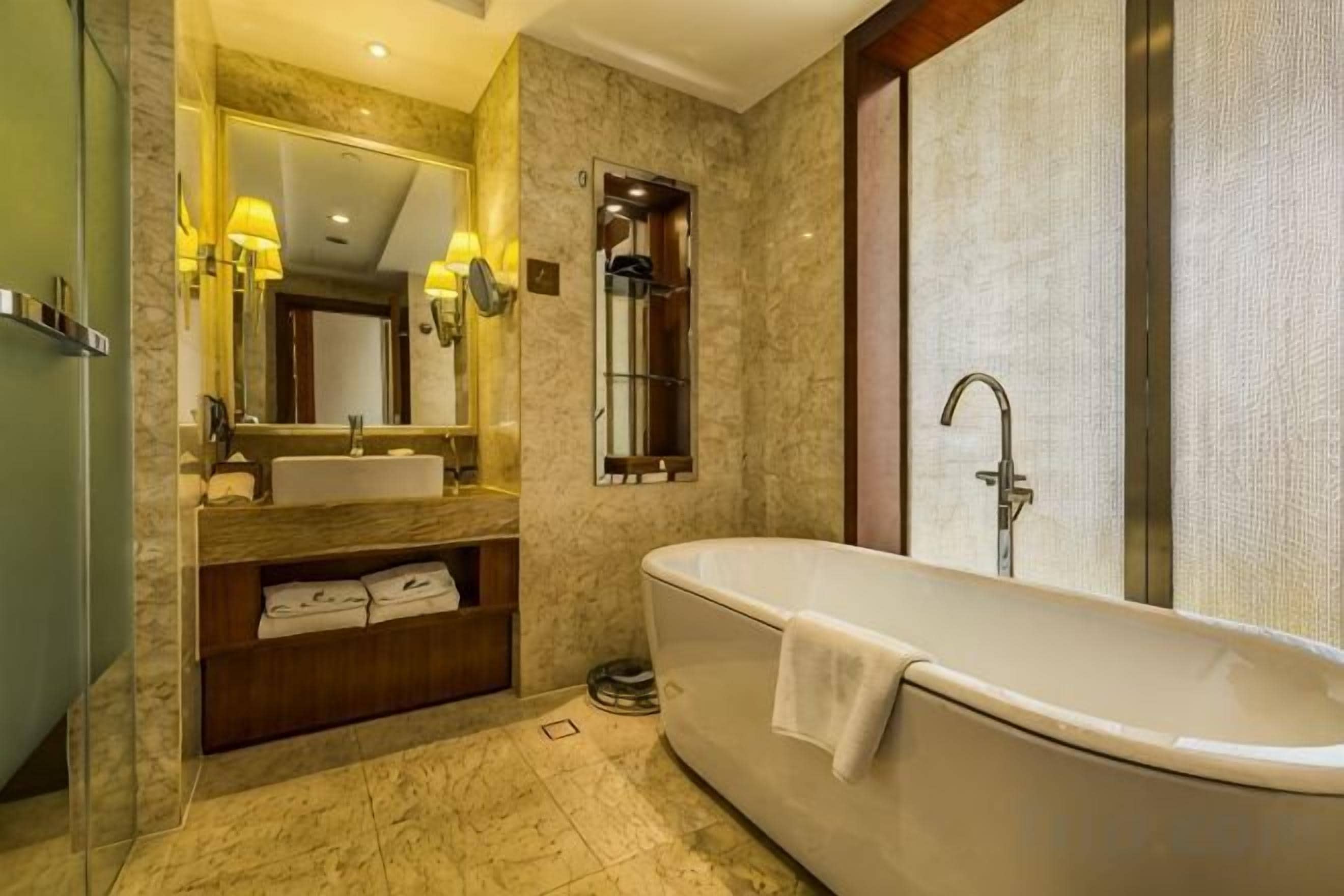 Un baño moderno con una bañera independiente, un tocador con espejo y una zona de ducha.
