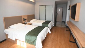A hotel room with two beds, a wooden bench, a TV mounted on the wall, and a sliding door closet. - Greentree Inn Shandong Linyi Yishui County Angel G (Linyi)