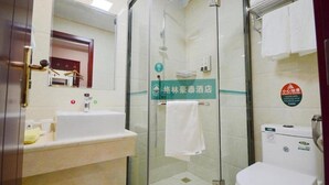 A hotel bathroom with a glass-enclosed shower, a sink, and a toilet. - Greentree Inn Shandong Linyi Yishui County Angel G (Linyi)