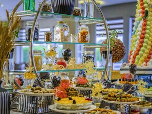 A buffet with various food items and decorative elements.