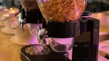 Two coffee machines with transparent containers filled with coffee beans.