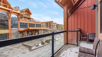A hotel reception area with a wooden balcony overlooking a snowy street.