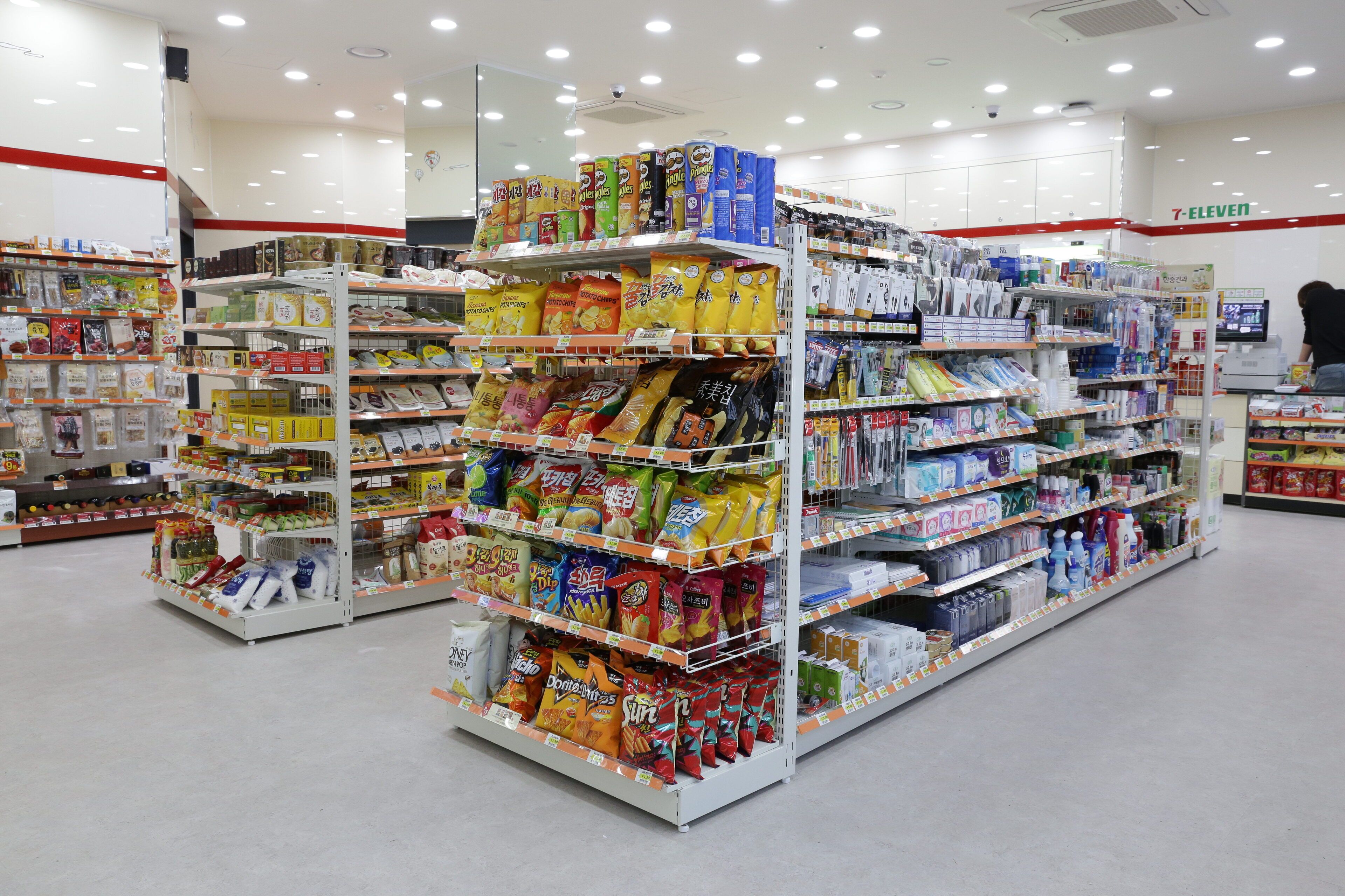 A supermarket aisle with various packaged goods and household items.