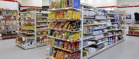 A supermarket aisle with various packaged goods and household items.