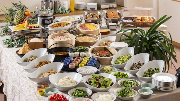 A buffet table with various food items and dishes. - Hotel Symphony (Sagae)
