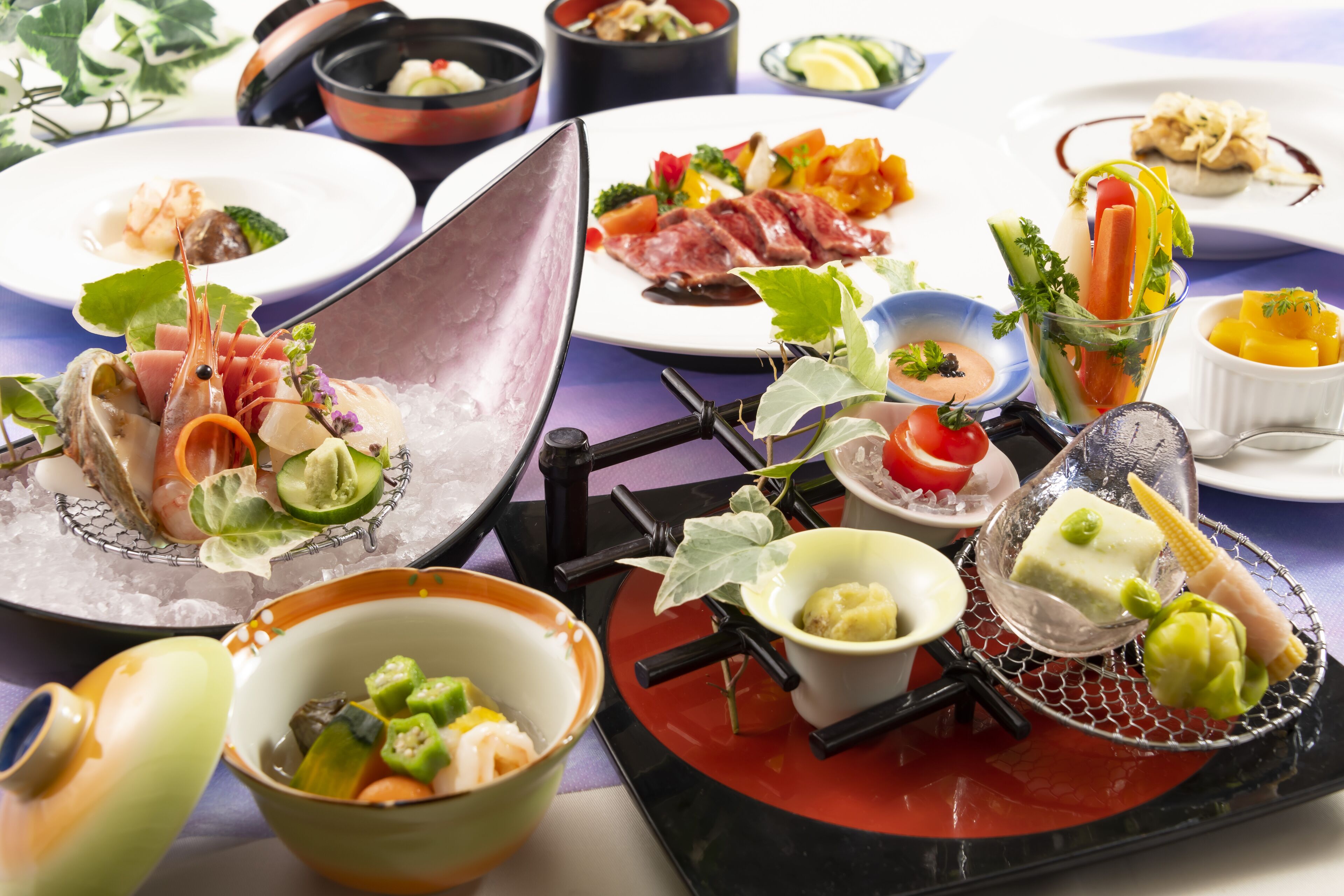 A variety of dishes on a table, including seafood, vegetables, and a dessert.