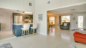 A spacious living area with a kitchen, a dining area, and a seating area with a sofa and chairs. - Canalfront Home w/ Dock & Pool: 5 Mi to Ft Myers! (North Fort Myers)