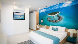 A bedroom with a bed, a nightstand, a desk, and a chair. There is a painting on the wall and a window. - Crystal Le Apartment Danang (Da Nang)