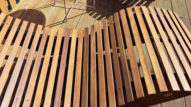A wooden deck with a pool, wooden lounge chairs, and a table with a glass. - Welcome to the beautiful 3 rivers city with Andrea and Axel <br> (Hann. Münden)